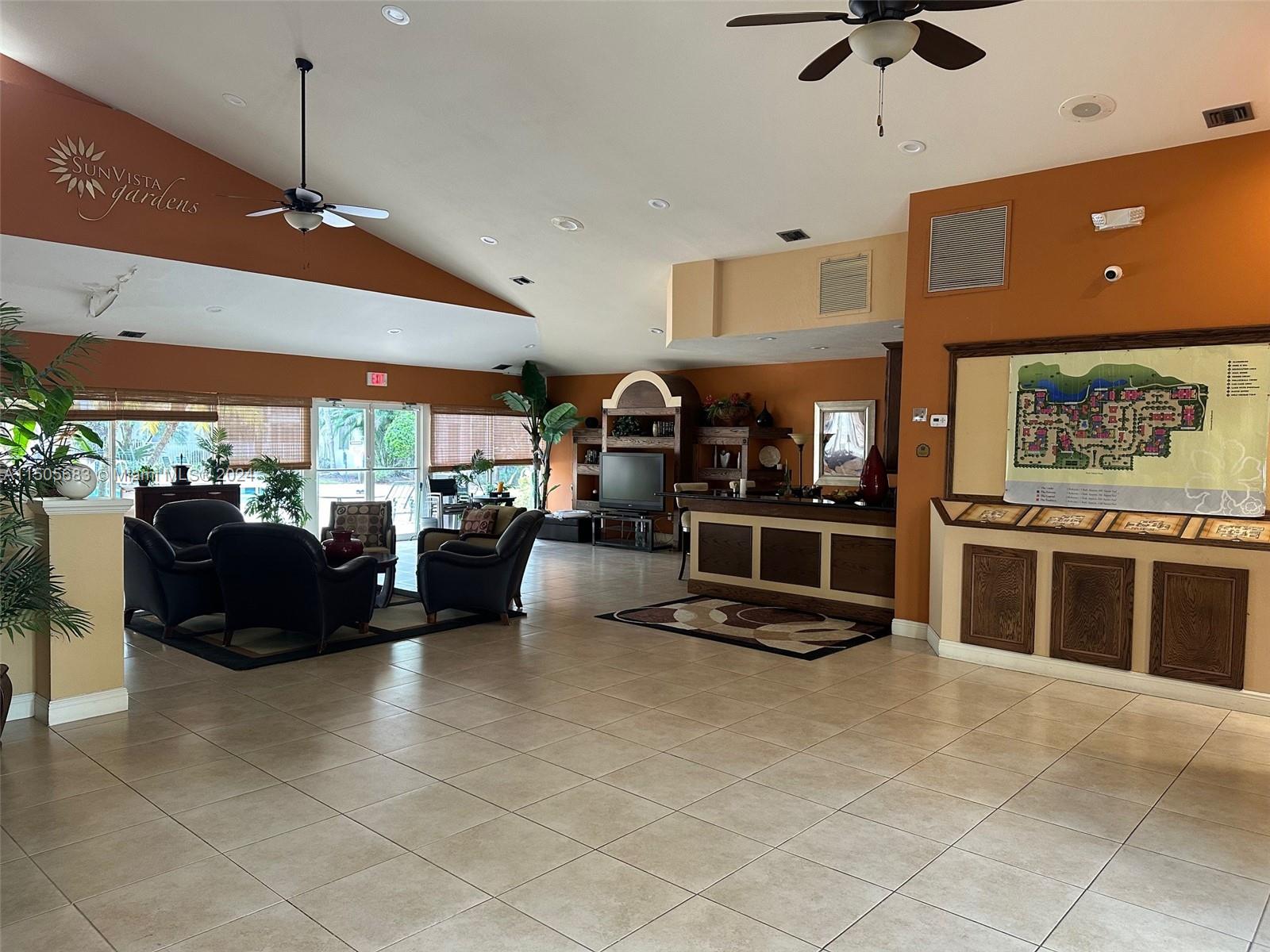 5686 Rock Island Road, Unit 134 Tamarac, FL 33319 - Photo 20 of 21 a living room with furniture a air conditioner and kitchen view