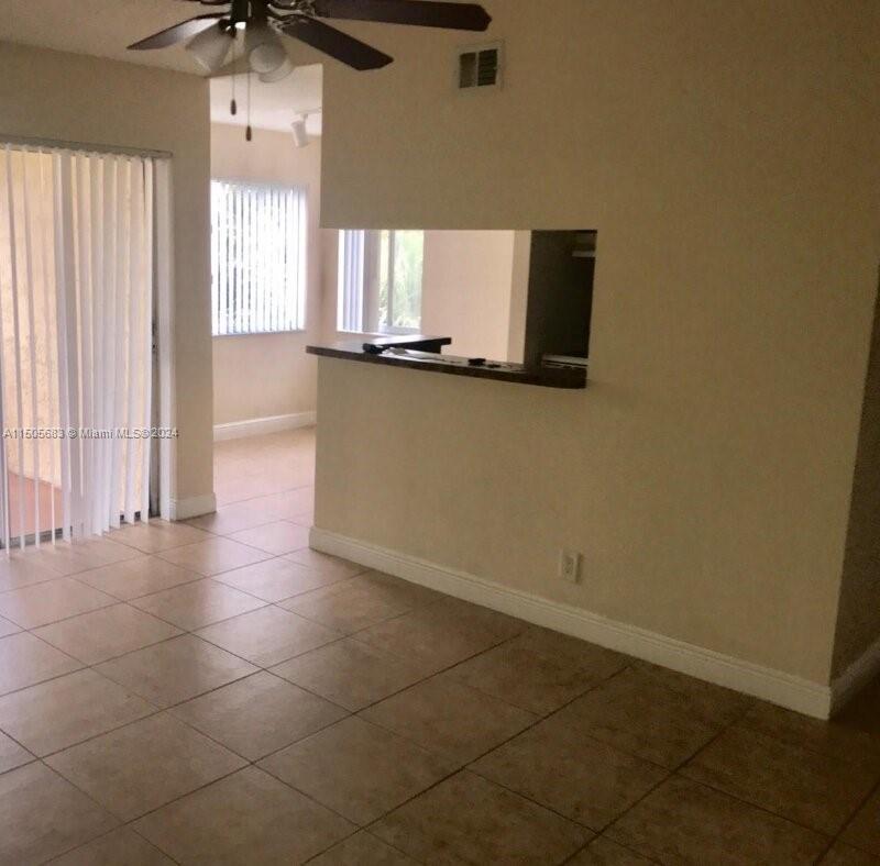 5686 Rock Island Road, Unit 134 Tamarac, FL 33319 - Photo 3 of 21 a bathroom with a sink vanity and a mirror