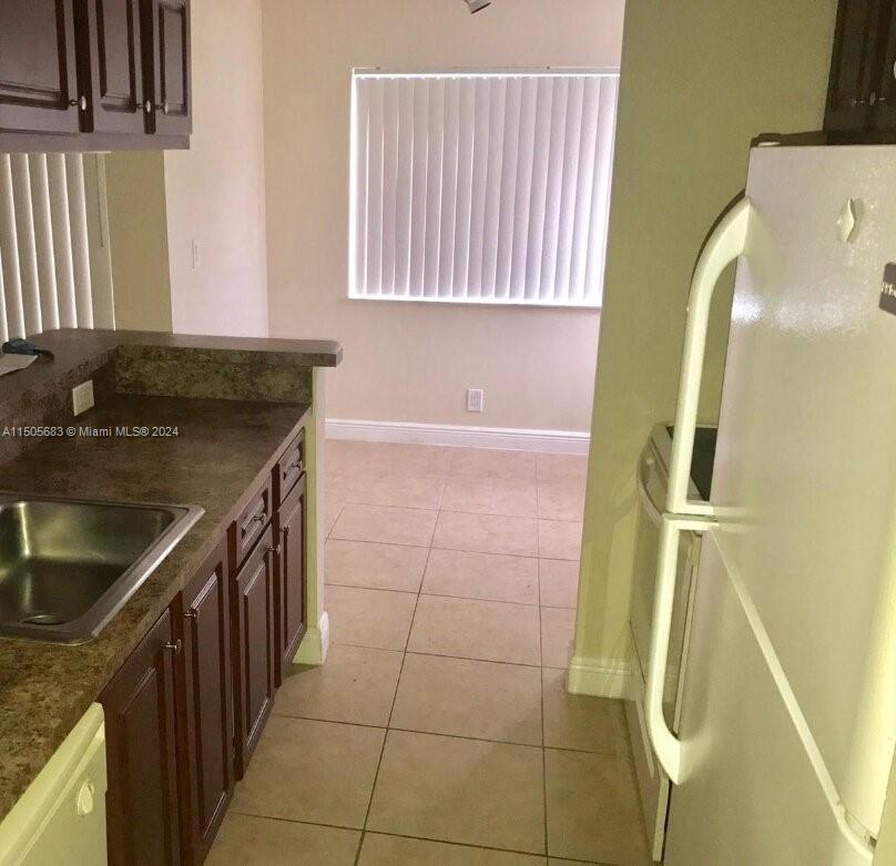 5686 Rock Island Road, Unit 134 Tamarac, FL 33319 - Photo 8 of 21 a bathroom with a sink and a mirror