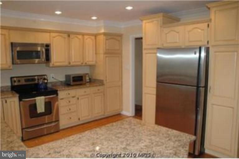 2141 Golf Course Drive Reston, VA 20191 - Photo 2 of 26 a kitchen with stainless steel appliances granite countertop a refrigerator a stove and a sink