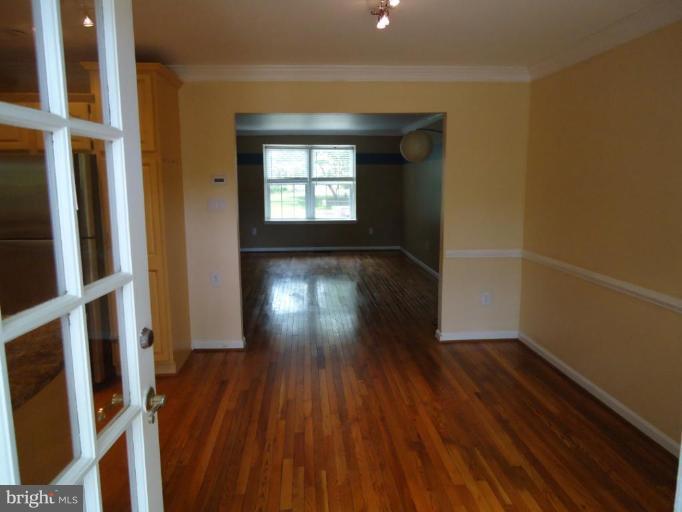 2141 Golf Course Drive Reston, VA 20191 - Photo 11 of 26 wooden floor in an empty room with a window