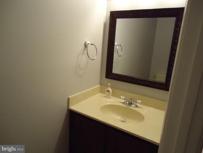 2141 Golf Course Drive Reston, VA 20191 - Photo 14 of 26 a bathroom with a sink and a mirror
