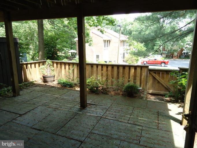 2141 Golf Course Drive Reston, VA 20191 - Photo 20 of 26 a view of a porch with a floor to ceiling window next to a yard
