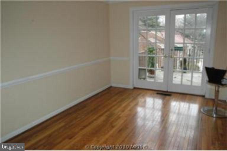2141 Golf Course Drive Reston, VA 20191 - Photo 3 of 26 a view of empty room with wooden floor and fan