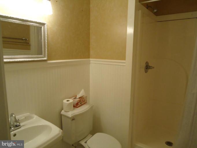 2141 Golf Course Drive Reston, VA 20191 - Photo 21 of 26 a white toilet sitting next to a bathroom sink