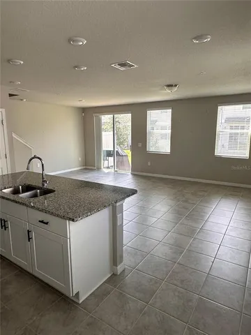 a kitchen with a sink a counter top space and a window