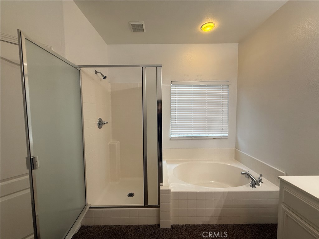 3518 Ranch Street Perris, CA 92571 - Photo 37 of 66 a bathroom with a tub a shower and a sink