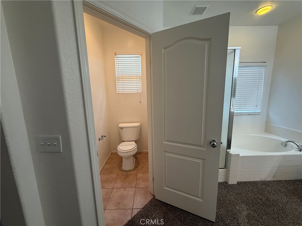 3518 Ranch Street Perris, CA 92571 - Photo 38 of 66 a bathroom with a granite countertop toilet and a sink