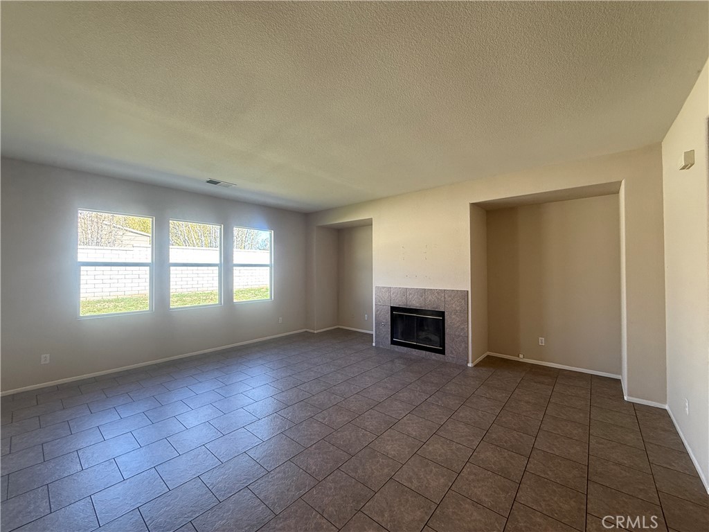 3518 Ranch Street Perris, CA 92571 - Photo 43 of 66 an empty room with fireplace and windows