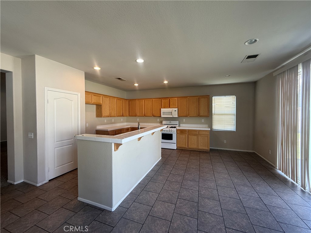 3518 Ranch Street Perris, CA 92571 - Photo 44 of 66 a kitchen with a refrigerator and a sink