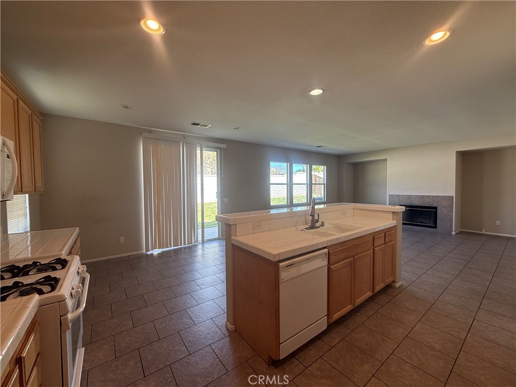 3518 Ranch Street Perris, CA 92571 - Photo 46 of 66 a kitchen with a sink stove and cabinets