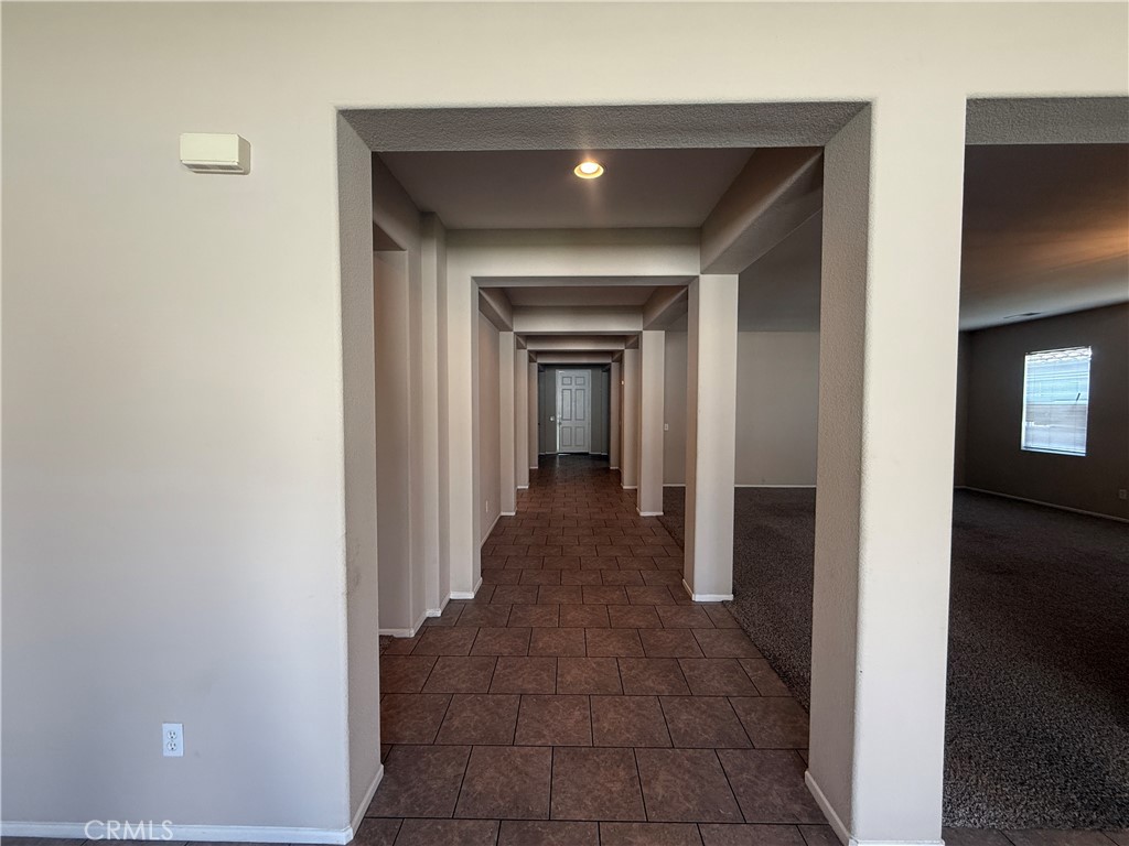 3518 Ranch Street Perris, CA 92571 - Photo 6 of 66 a view of a hallway with wooden floor and a living room