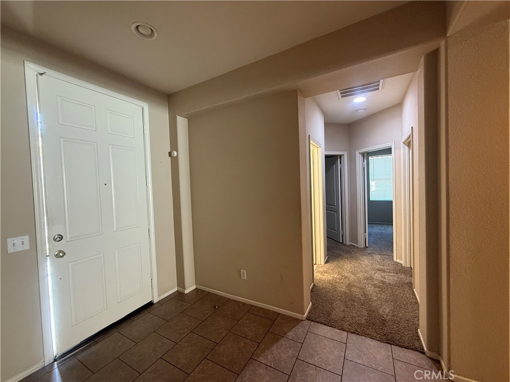 3518 Ranch Street Perris, CA 92571 - Photo 7 of 66 a view of a hallway with wooden shelves