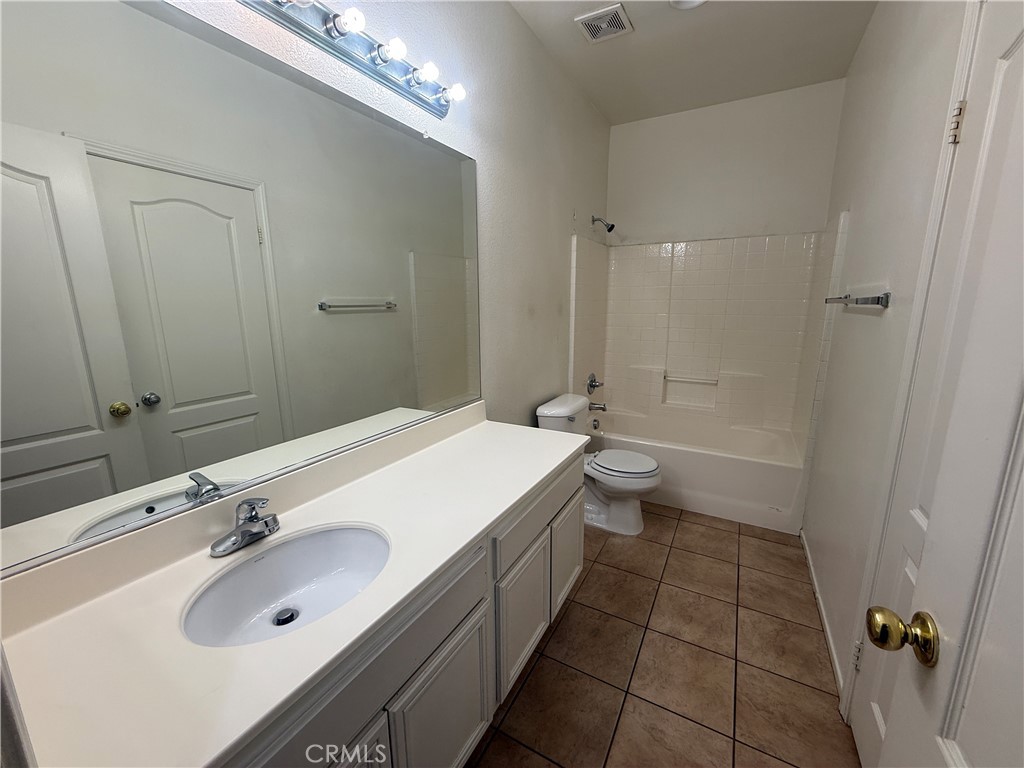 3518 Ranch Street Perris, CA 92571 - Photo 9 of 66 a bathroom with a sink a toilet and shower