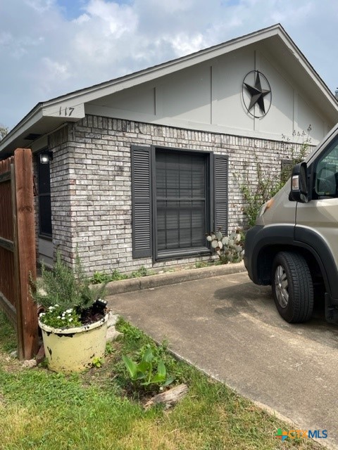 117 East Crockett Street Luling, TX 78648 - Photo 1 of 4 a front view of a house with a yard