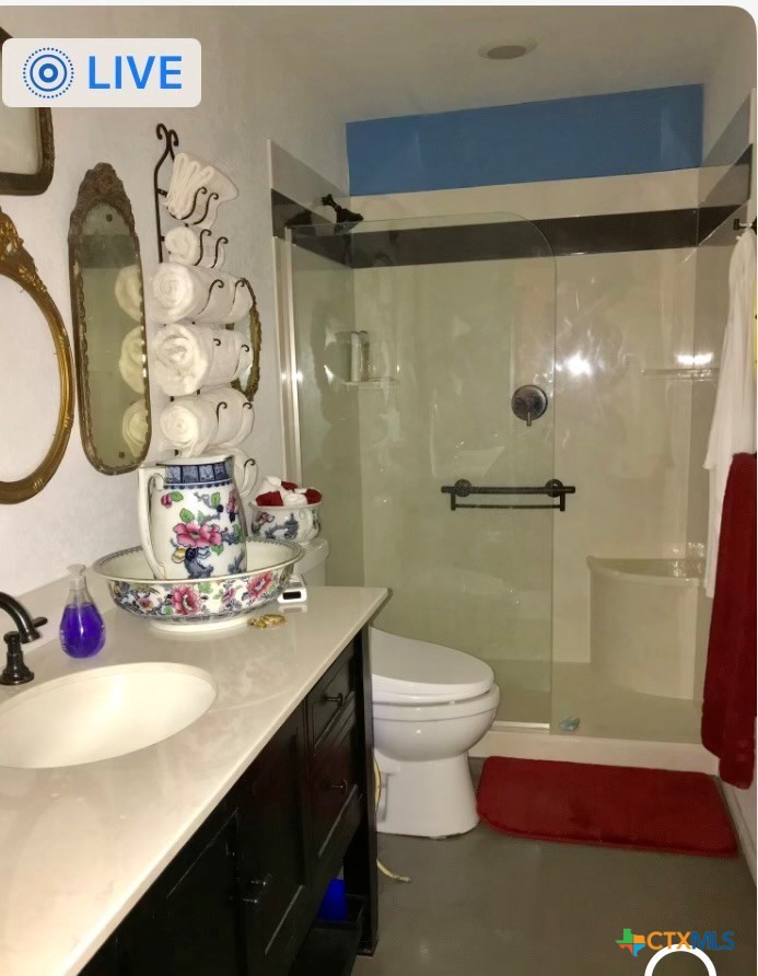 117 East Crockett Street Luling, TX 78648 - Photo 2 of 4 a bathroom with a sink and mirror