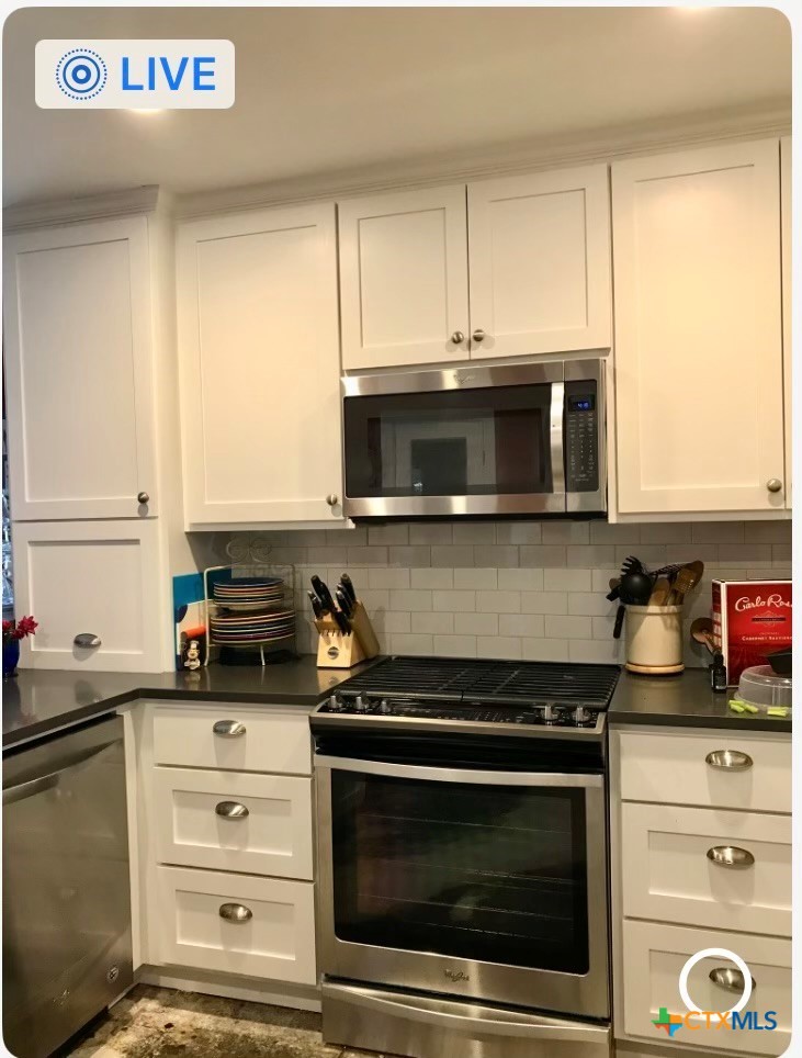 117 East Crockett Street Luling, TX 78648 - Photo 4 of 4 a kitchen with stainless steel appliances a stove a microwave and cabinets