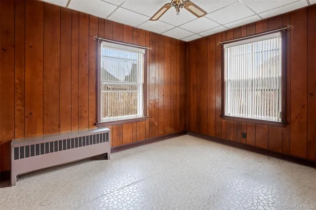 an empty room with a piano and wooden floor