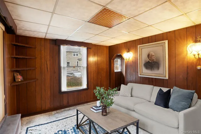 a living room with furniture and wall paintings