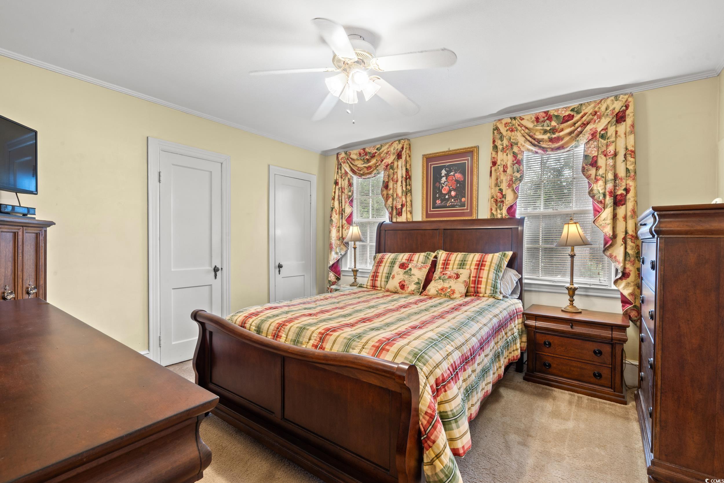 310 North Main Street Mullins, SC 29574 - Photo 22 of 35 Bedroom featuring multiple windows, ornamental molding, light carpet, and a ceiling fan