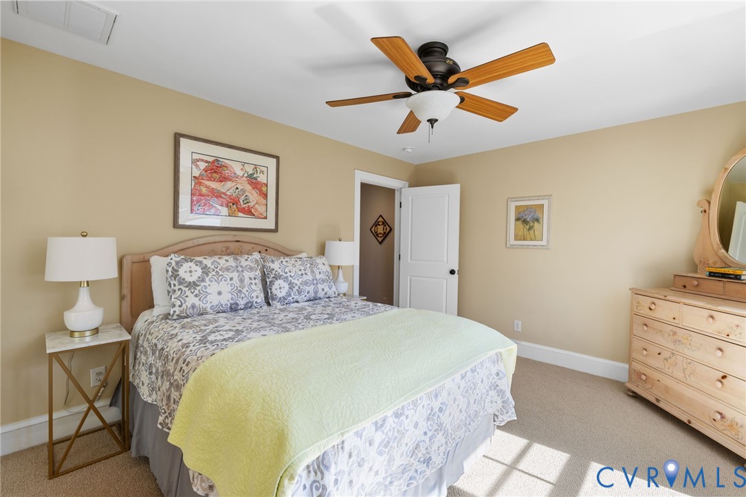 8947 Cherokee Road Richmond, VA 23235 - Photo 35 of 45 a bedroom with a bed and a chandelier