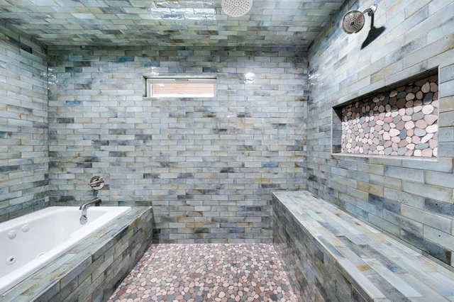 a bathroom with a bathtub and a shower