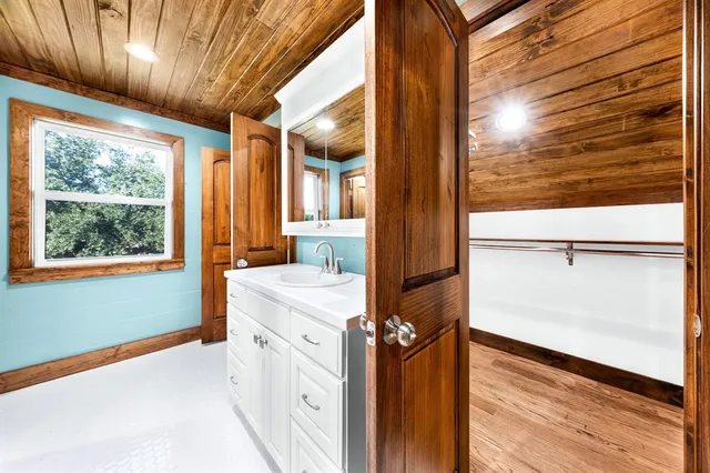 a kitchen view with wooden floor and windows