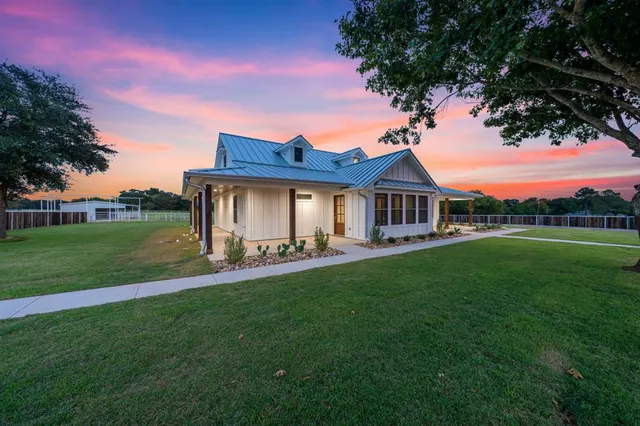 a front view of a house with yard and green space