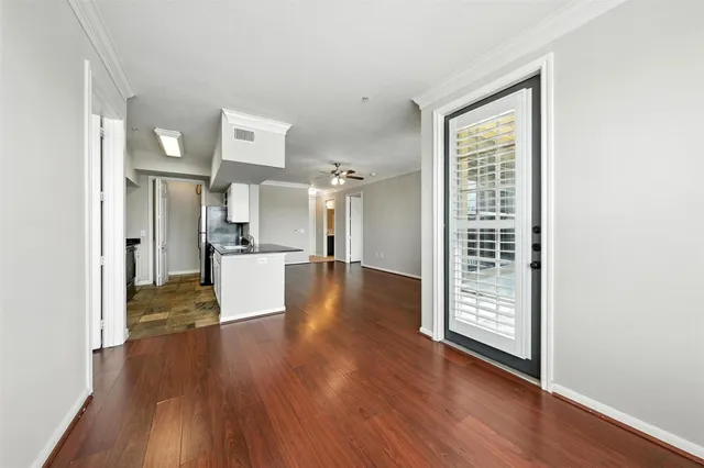 a view of a kitchen with wooden floor and a window