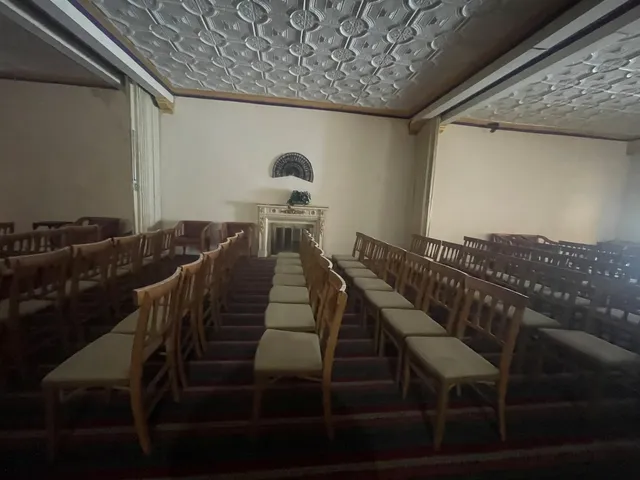 a dining room with table chairs and wooden floor