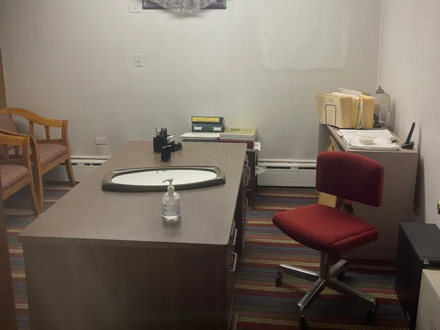 a living room with a black white checkered floor with a dining table and chair