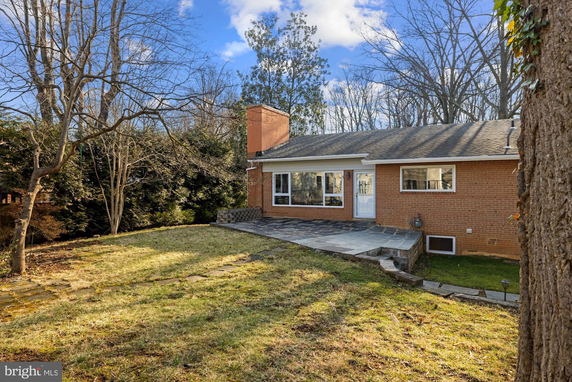 7716 Beech Tree Road Bethesda, MD 20817 - Photo 30 of 49 a backyard of a house with yard and tree