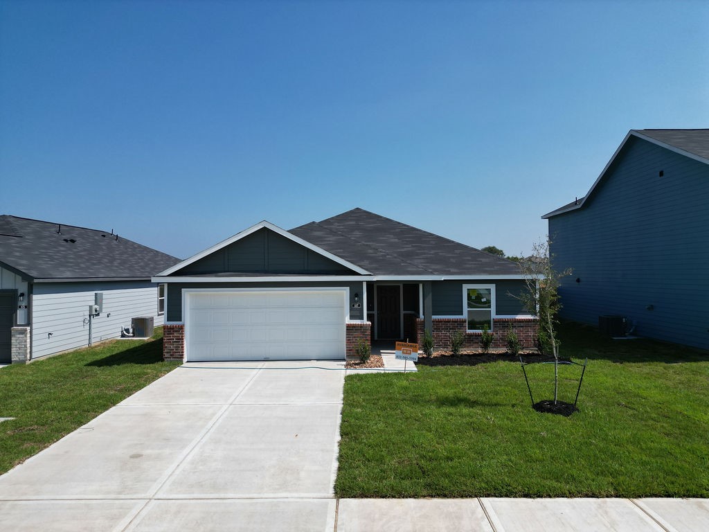 a front view of a house with a yard and green space