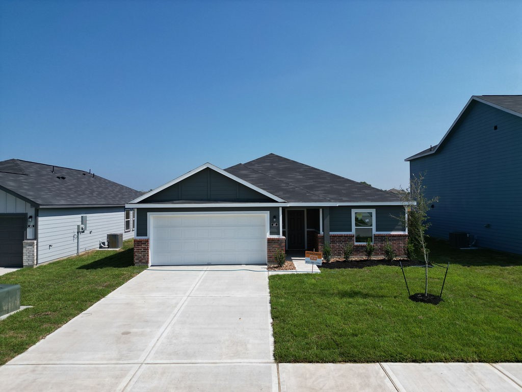 807 Stoney Point Lane Dayton, TX 77535 - Photo 2 of 19 a front view of a house with a yard and green space