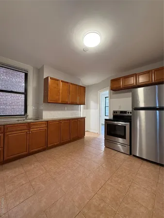 a kitchen with stainless steel appliances a refrigerator and a sink