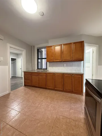a kitchen with a cabinets and window