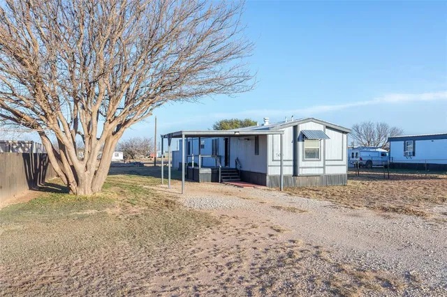 a view of a house with a yard covered in snow