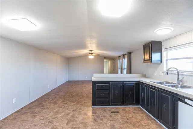 a spacious bathroom with a granite countertop sink and a mirror