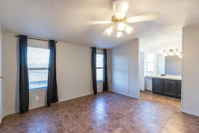 a view of a livingroom with a ceiling fan and window