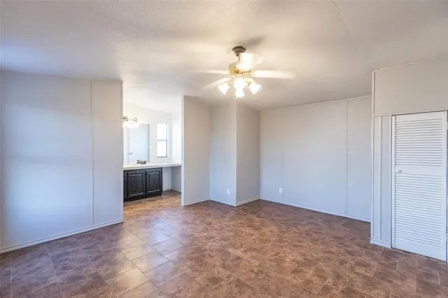 a view of a kitchen with a sink and a chandelier fan