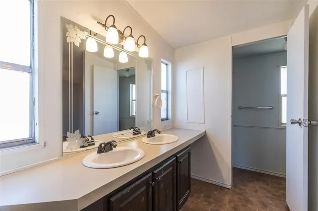 a bathroom with a sink vanity and a mirror