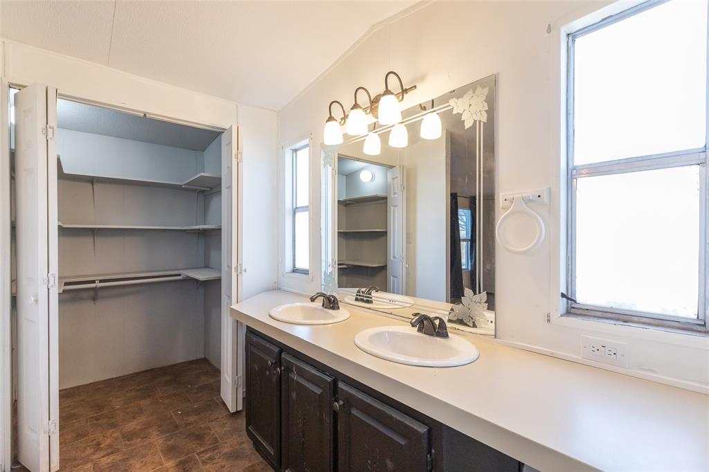 709 Gibson Street Tye, TX 79603 - Photo 23 of 26 a bathroom with a double vanity sink mirror and double