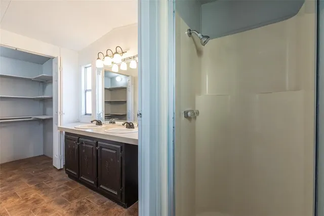 a bathroom with a double vanity sink and mirror