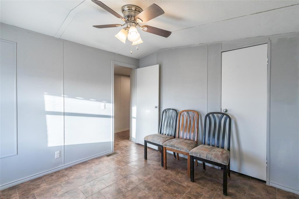 709 Gibson Street Tye, TX 79603 - Photo 10 of 26 a view of a room with window a ceiling fan and wooden floor