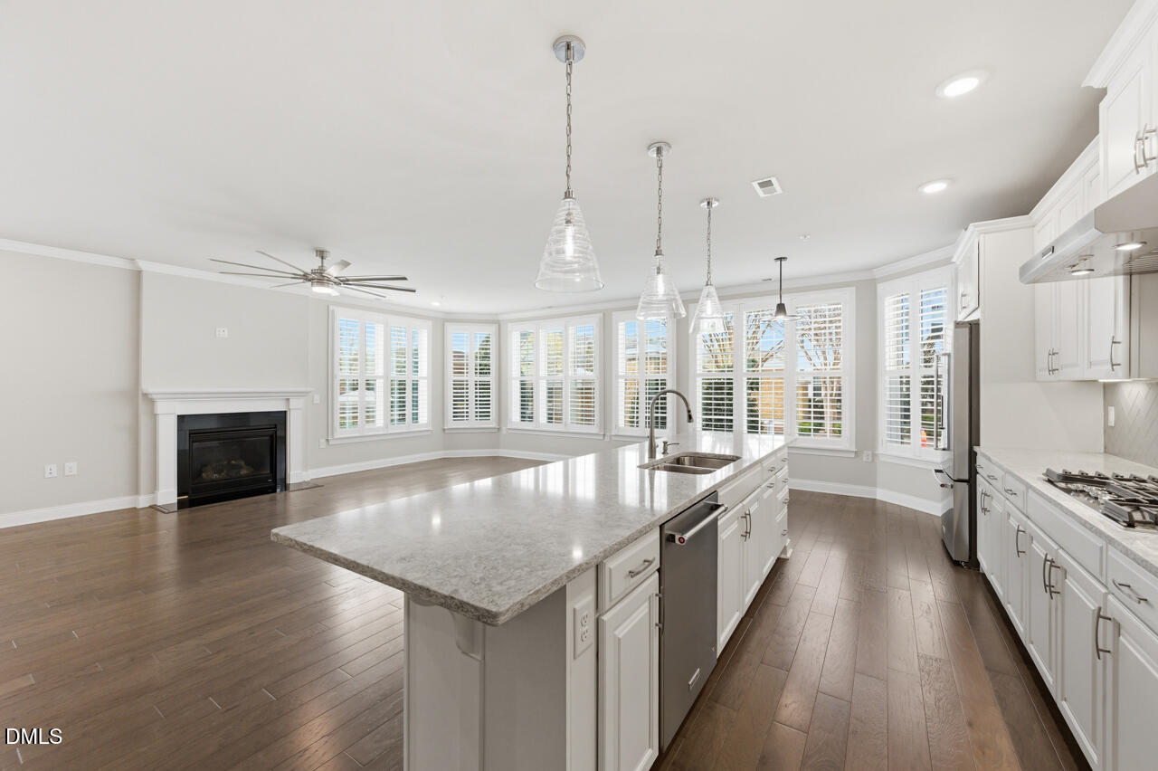 10210 Sablewood Drive, Unit 114 Raleigh, NC 27617 - Photo 12 of 28 a large kitchen with kitchen island granite countertop a large center island and stainless steel appliances