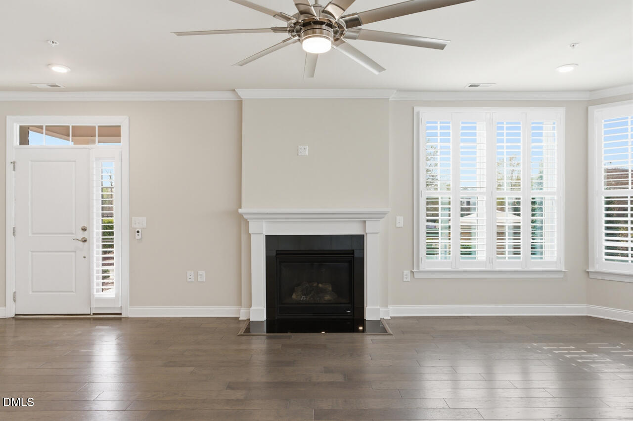 10210 Sablewood Drive, Unit 114 Raleigh, NC 27617 - Photo 14 of 28 a view of an empty room with wooden floor fireplace and a window