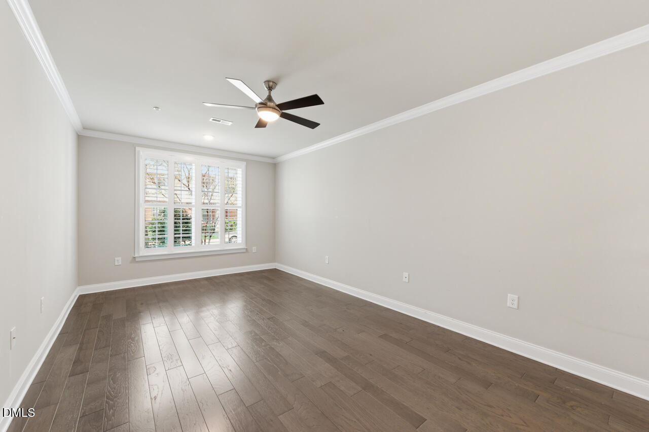 10210 Sablewood Drive, Unit 114 Raleigh, NC 27617 - Photo 17 of 28 wooden floor in an empty room with a window