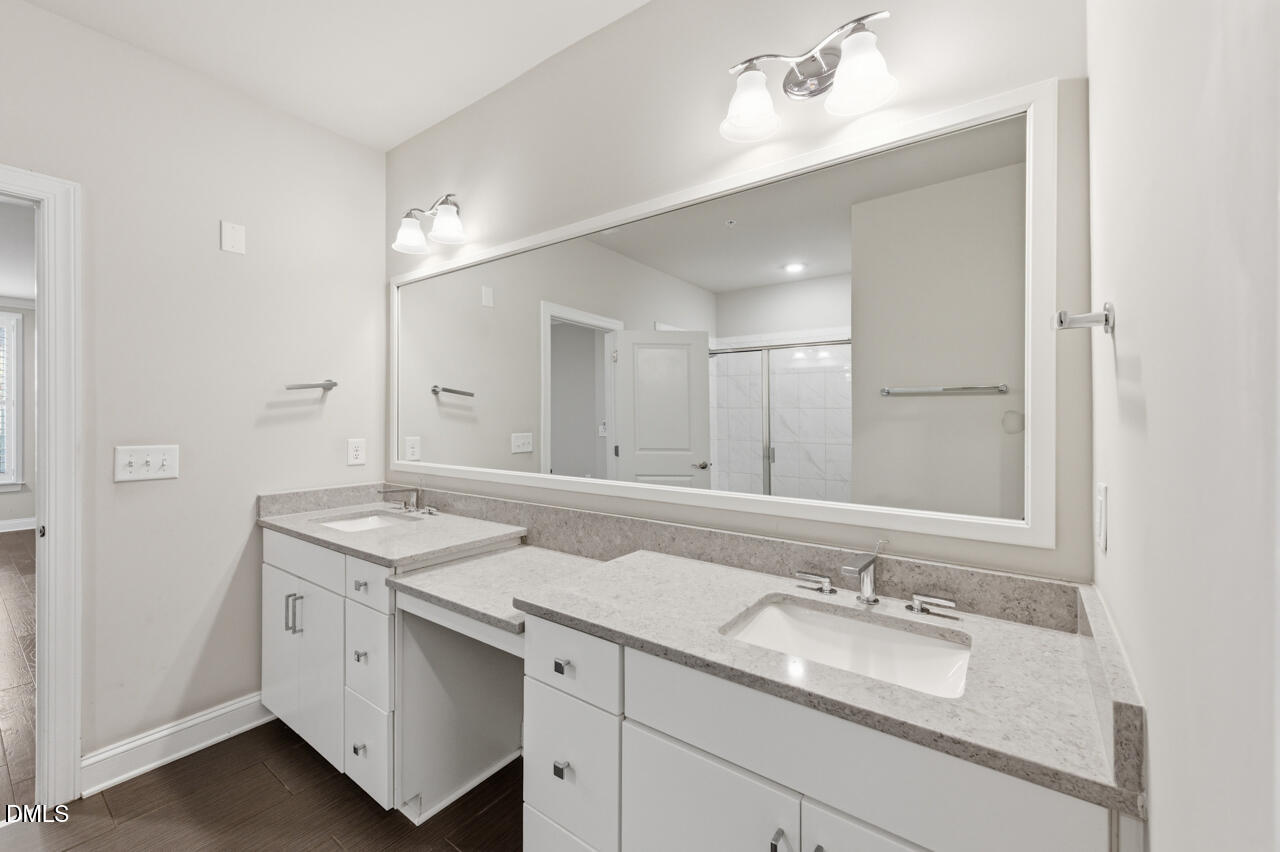 10210 Sablewood Drive, Unit 114 Raleigh, NC 27617 - Photo 20 of 28 a bathroom with a sink and a mirror