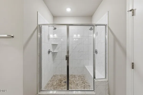 a bathroom with a glass shower door