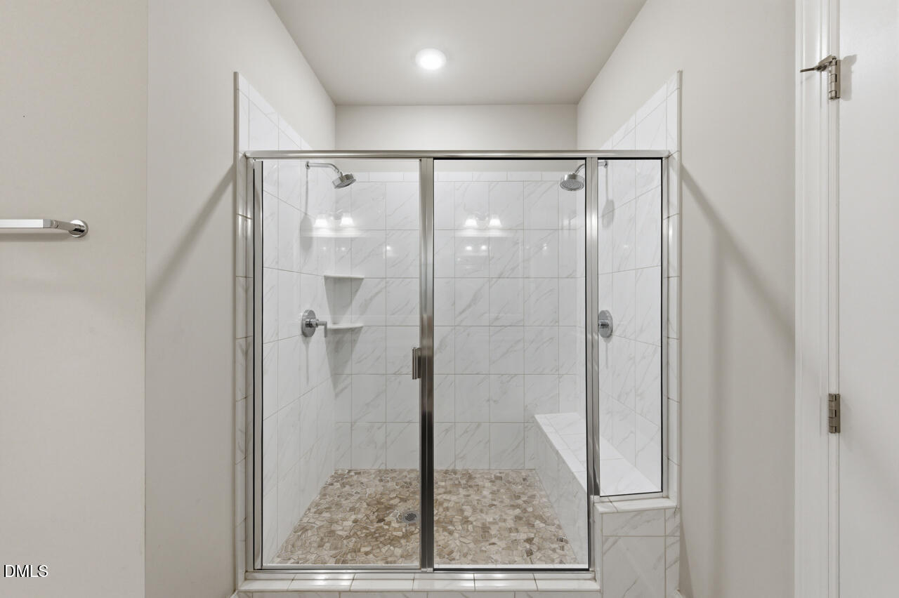 10210 Sablewood Drive, Unit 114 Raleigh, NC 27617 - Photo 21 of 28 a bathroom with a glass shower door